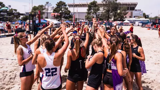 TCU beach volleyball team huddle