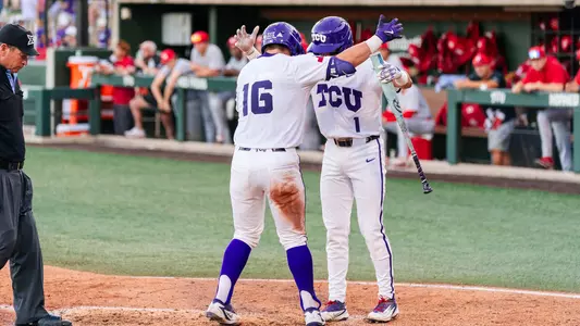 Nolan Traeger and Jack Bell knock helmets at home plate after Traeger's home run in the sixth.
