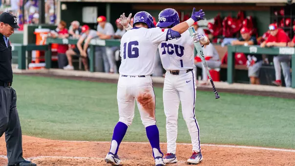Nolan Traeger and Jack Bell knock helmets at home plate after Traeger's home run in the sixth.