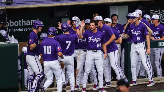 Cole Cramer and Sawyer Strosnider celebrate with teammates in the dugout after scoring the go-ahead runs against Houston.