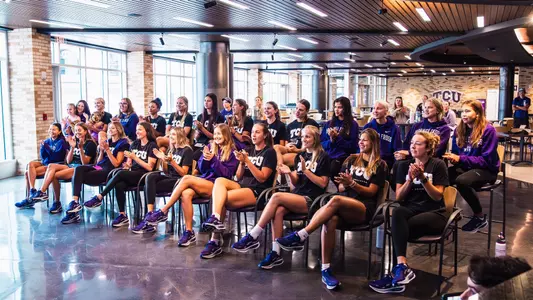 TCU beach volleyball team clapping at the NCAA Selection Show party