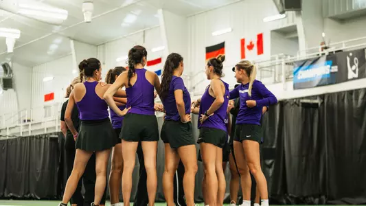 TCU women's tennis team huddling on court at the LSU Tennis center