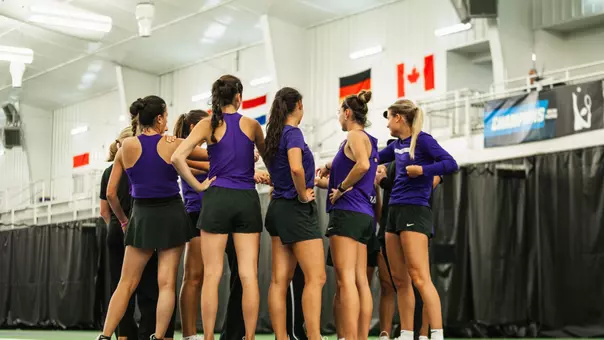 TCU women's tennis team huddling on court at the LSU Tennis center