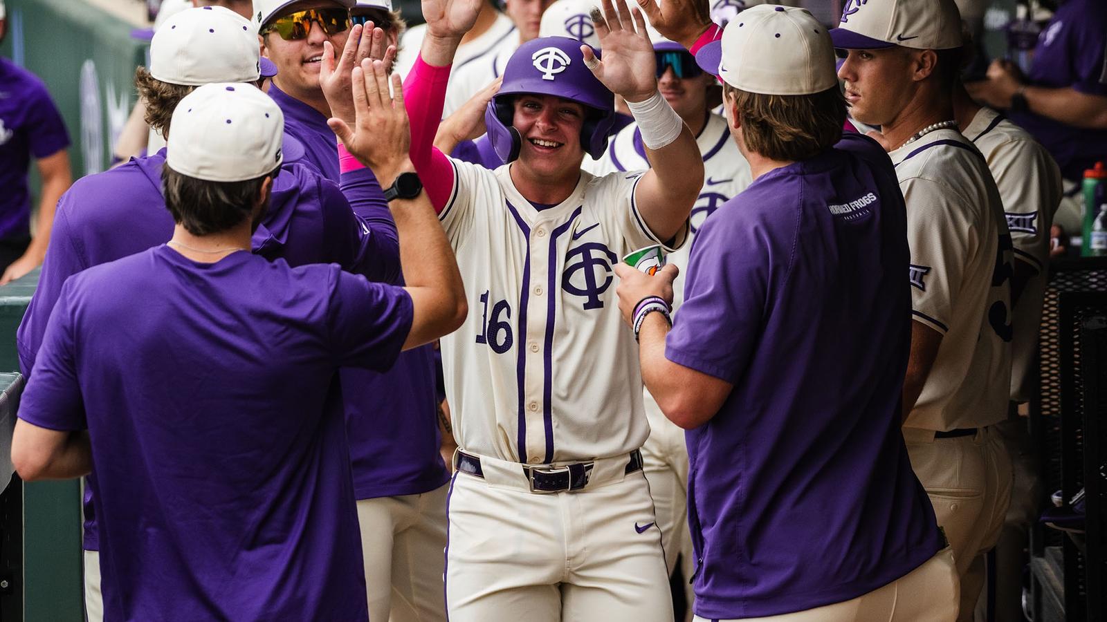 Nolan Traeger receives congratulations from his teammates in the dugout.