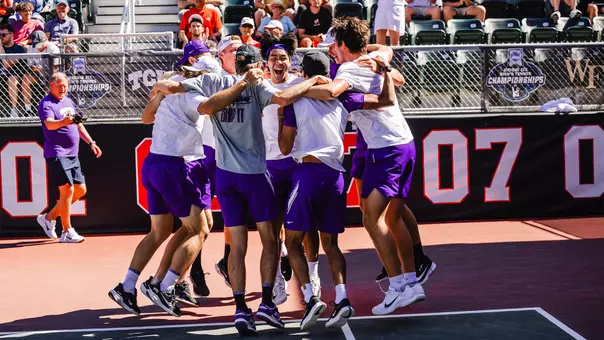 The TCU men's tennis team celebrates after clinching a 4-3 victory over Ohio State.