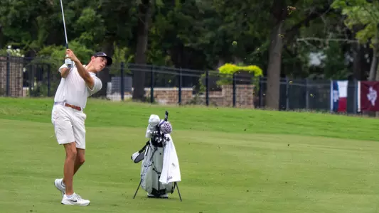 Nathan Miller follows through after an iron shot in the fairway.