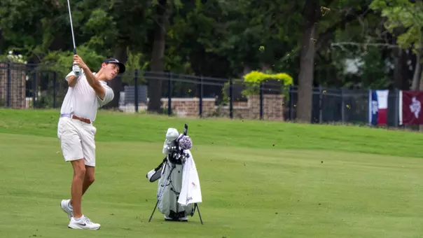 Nathan Miller follows through after an iron shot in the fairway.