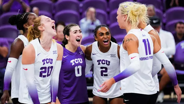 TCU Volleyball players celebrate scoring a point together