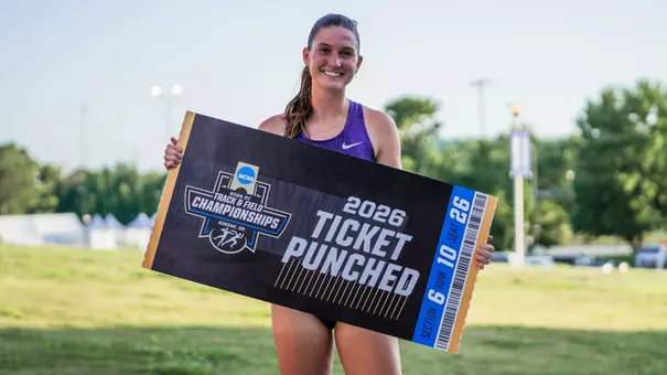 Georgia Scott holding a ticket punched sign for the NCAA Championships
