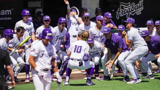 Sawyer Strosnider celebrates his home run with his teammates in front of the dugout at Lupton Stadium.