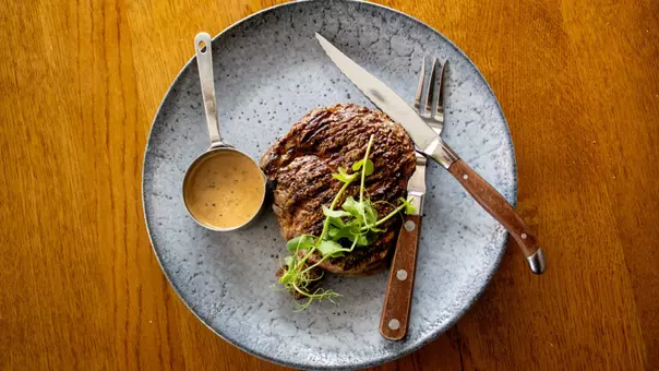 Steak with utensils on a plate