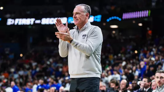 Jamie Dixon claps his hands.