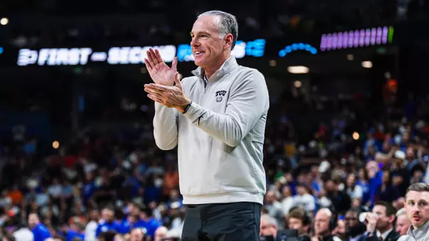 Jamie Dixon claps his hands.