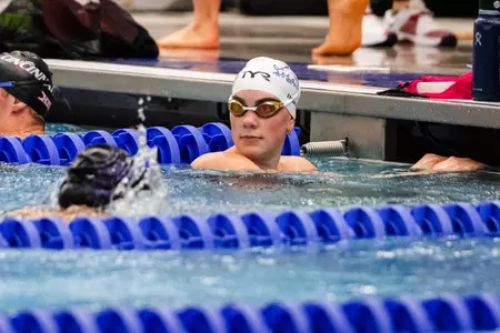 Sydney Inman looks at the scoreboard after finishing the race