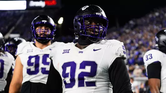 Ansel Din-Mbuh in a white jersey and black helmet