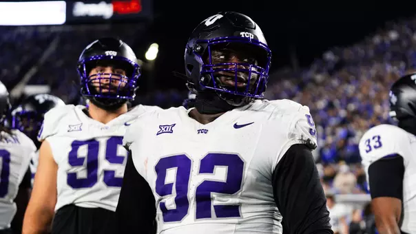 Ansel Din-Mbuh in a white jersey and black helmet