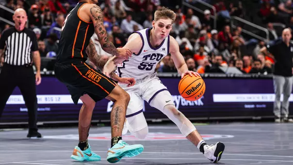 Tanner Toolson drives the ball against Oklahoma State