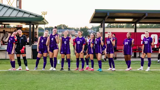 TCU women's soccer starting XI against Alabama smiling at camera