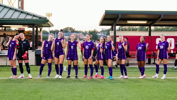 TCU women's soccer starting XI against Alabama smiling at camera