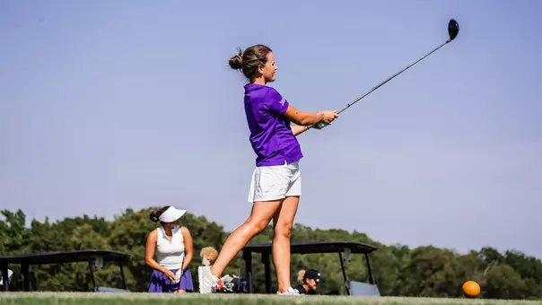 Ella Forss follows through on a tee shot and tracks her ball path