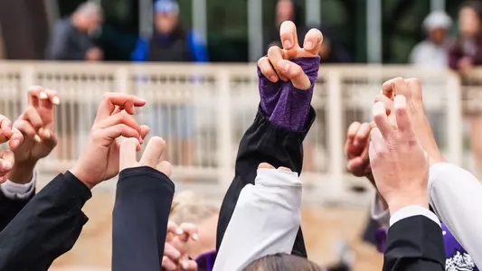 TCU beach volleyball players with the Frog Sign