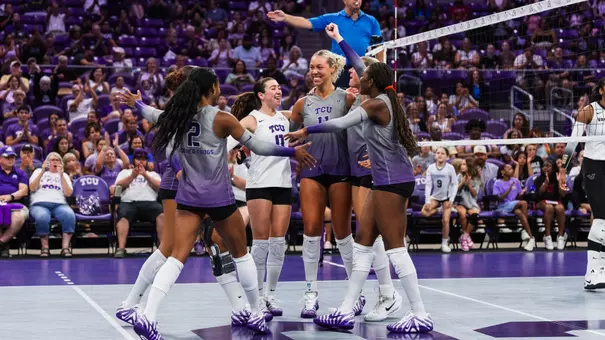 TCU Volleyball huddles together and celebrates a point