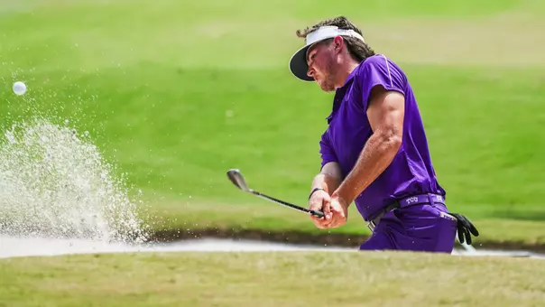 Cameron Kuchar swings out of the bunker wearing all purple