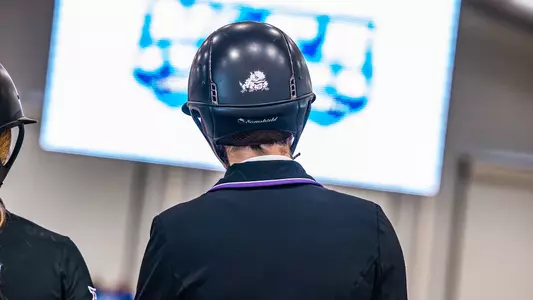 Photo of the back of a jumping seat riders helmet