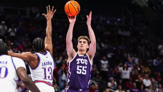 Tanner Toolson shoots the ball over Kansas defender at the Big 12 Tournament