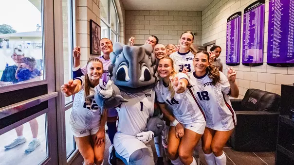 TCU women's soccer team with Super Frog