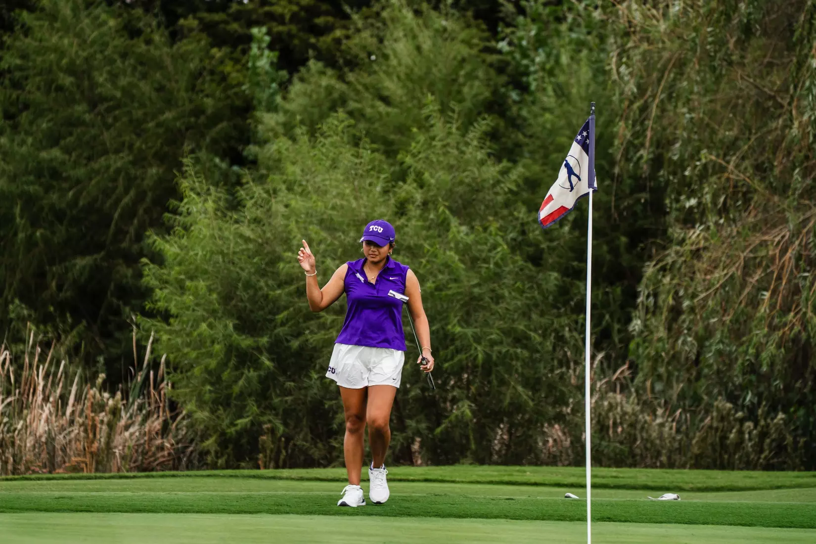 Kirstin Angosta celebrates after rolling in a long birdie putt.