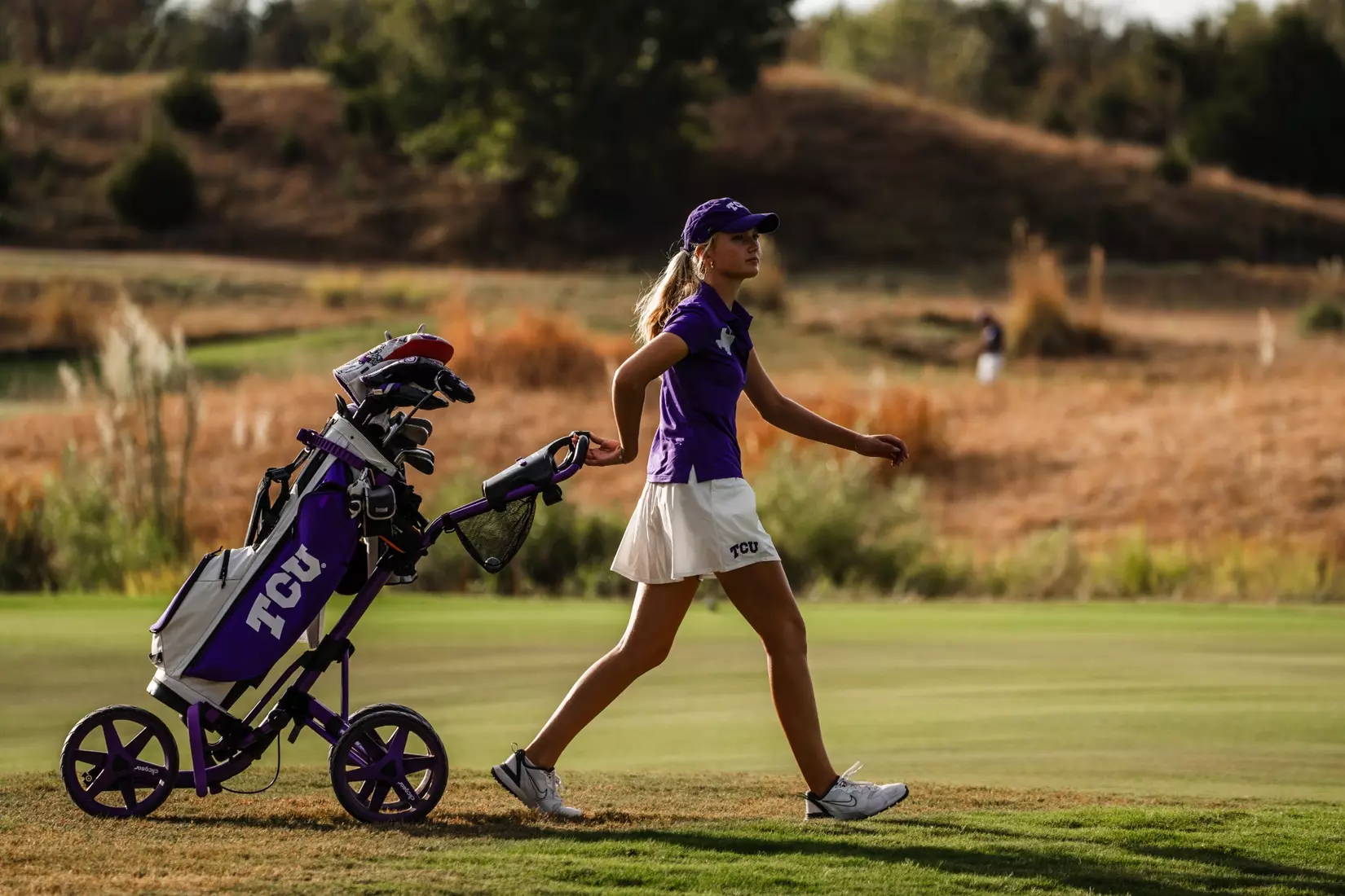 Henriette Gjelten pulls her golf bag along the fairway.