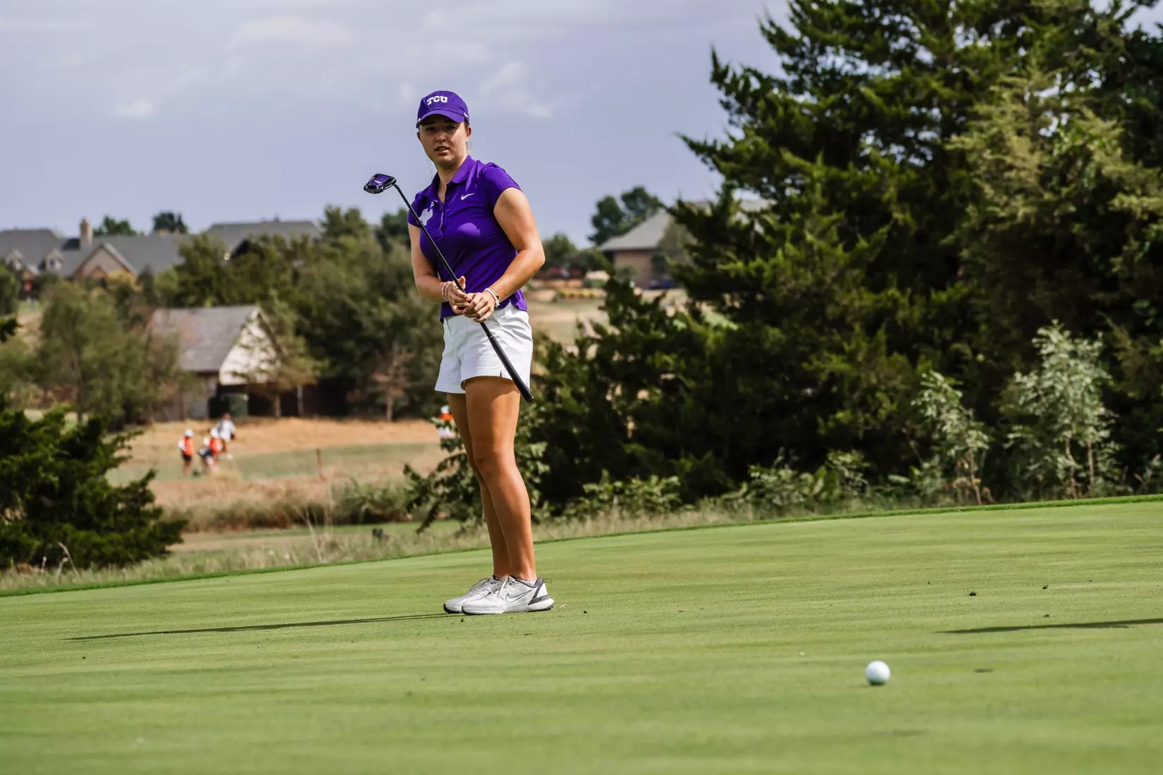 Sofie Dimitrova grips her putter and watches the ball roll toward the hole.