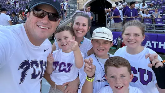 Heston Goggins and family on the field at a TCU Football Game