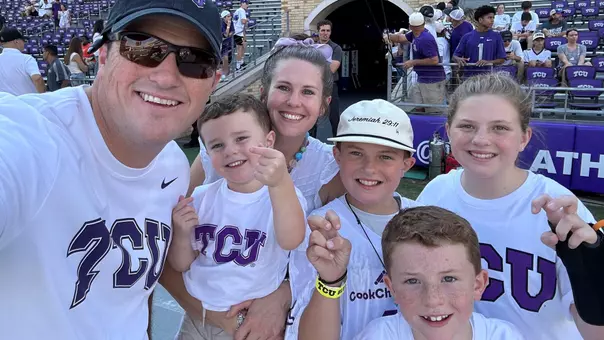 Heston Goggins and family on the field at a TCU Football Game