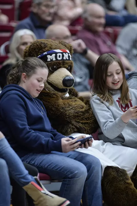 Monte sits with fans during a college basketball game between the Montana Grizzlies and the Eastern Washington University Eagles at Dahlberg Arena on January 29, 2022 in Missoula, Montana. Montana beat Eastern Washington 61-59.