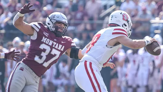 Marcus Welnel #37 of the Montana Grizzlies sacks Carson Camp #18 of the South Dakota Coyotes in the fourth quarter of a college football game at Washington-Grizzly Stadium on September 10, 2022 in Missoula, Montana.Montana beat South Dakota 24-7.