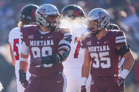 Alex Gubner #99 of the Montana Grizzlies and Braxton Hill #35 of the Montana Grizzlies during a college football game against the Eastern Washington Eagles at Washington-Grizzly Stadium on November 5, 2022 in Missoula, Montana.