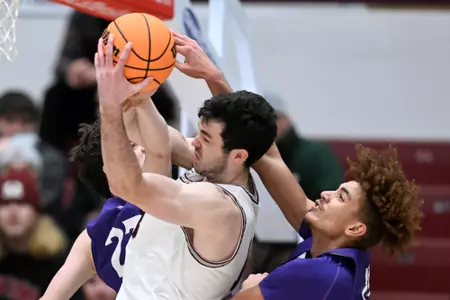 Montana Grizzlies forward Josh Bannan #13 pulls down a rebound during a college basketball game against the St. Thomas Tommies at Dahlberg Arena on November 17, 2022 in Bozeman, Montana.