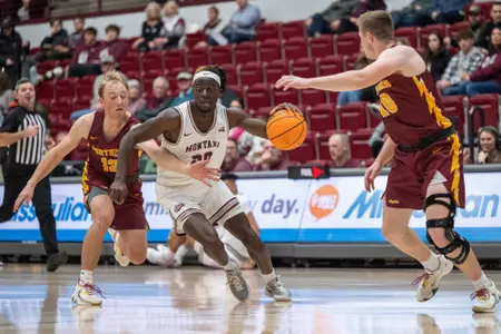 Jonathan Brown #20 of the Montana Grizzlies drives the ball to the basket during the first half against Montana State-Northern at Dahlberg Arena on Tuesday, Nov. 22, 2022.