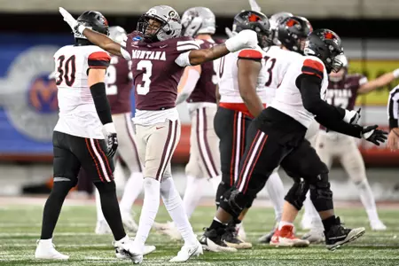 TraJon Cotton #3 of the Montana Grizzlies celebrates a stop in the third quarter of a game against the Southeast Missouri State Redhawks at Washington-Grizzly Stadium on November 26, 2022 in Missoula, Montana.