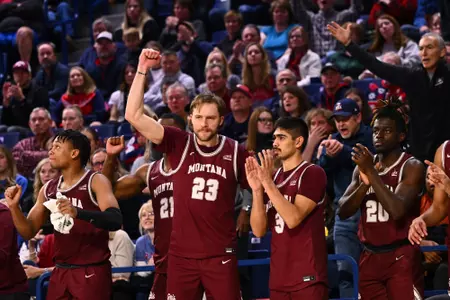 Mack Anderson #23 of the Montana Grizzlies cheers from the bench after the Montana Grizzlies score against the Gonzaga Bulldogs during the second half at McCarthey Athletic Center on December 20, 2022 in Spokane, Washington.