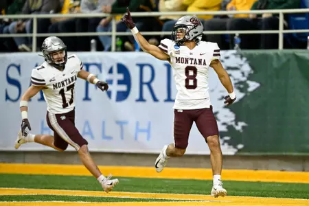 Corbin Walker #8 of the Montana Grizzlies reacts after scoring on a interception in the third quarter of a game against the North Dakota State Bison at the Fargodome on December 3, 2022 in Fargo, North Dakota.