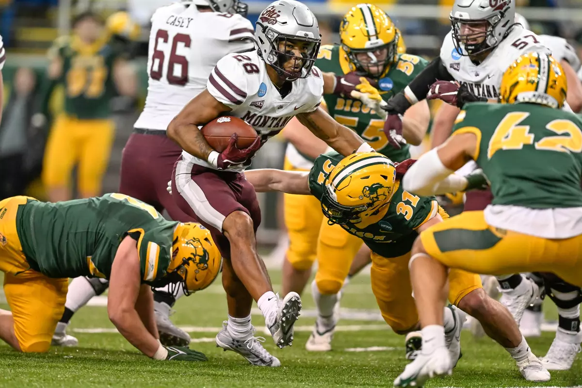 Isiah Childs #28 of the Montana Grizzlies runs with the ball in the fourth quarter of a game against the North Dakota State Bison at the Fargodome on December 3, 2022 in Fargo, North Dakota.