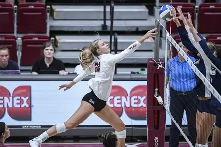 Maddie Kremer #22 of the Montana Grizzlies hits the ball over the net during a college volleyball game between the Montana Grizzlies and the UC Davis Aggies Dahlberg Arena on August 27, in Missoula, Montana.