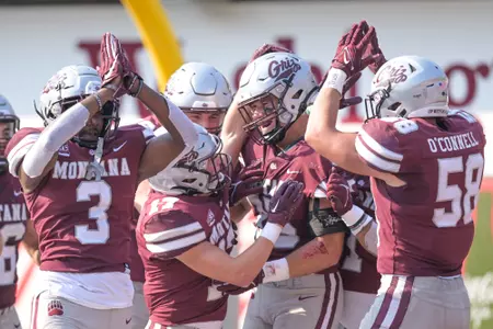 Braxton Hill #35 of the Montana Grizzlies celebrates a safety with teammates in the fourth quarter of a college football game against the University of South Dakota Coyotes at Washington-Grizzly Stadium on September 10, 2022 in Missoula, Montana. Montana beat South Dakota 24-7.
