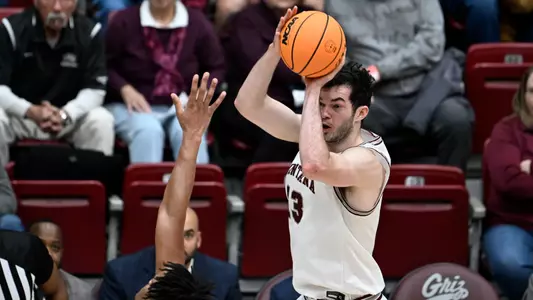 Josh Bannan #13 of the Montana Grizzlies shoots a 3-pointer during a college basketball game against the Weber State Wildcats at Dahlberg Arena on January 12, 2023 in Missoula, Montana.