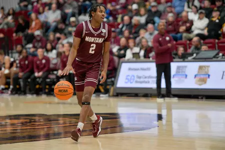 Chase Henderson #2 of the Montana Grizzlies dribbles the ball downcourt during the first half at Robin Selvig Court inside Dahlberg Arena on November 16, 2023 in Missoula, Montana.