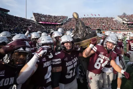 Evan Shafer #84 of the Montana Grizzlies carries the Great Divide trophy after the game against the Montana State Bobcats at Washington-Grizzly Stadium in Missoula, Montana on November 18, 2023.