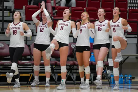 The Montana Grizzlies celebrate after scoring a point during the fourth set of a college volleyball match between the Montana Grizzlies and the Northern Arizona Lumberjacks at Dahlberg Arena on November 2, 2023 in Missoula, Montana.